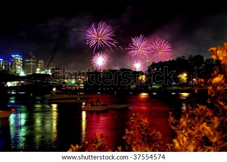 Fireworks reflected in the Brisbane water with skyscrapers during the river fire festival