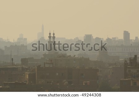 High density living in the smog and setting sun old Islamic Cairo quarter Egypt