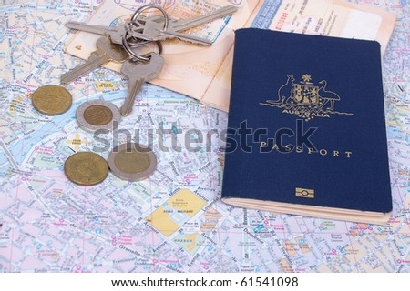 australian passport and keys on top of paris map