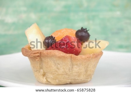 fruit cup sweet-crust pastry on white plate