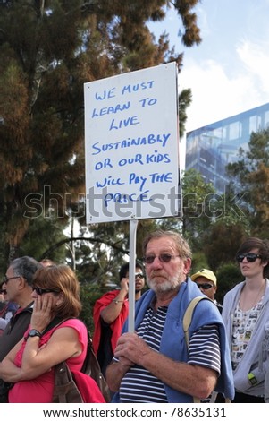 BRISBANE, AUSTRALIA - JUNE 6 : man with sustainability sign during World Environment Day say yes protest 6, 2011 in Brisbane, Australia