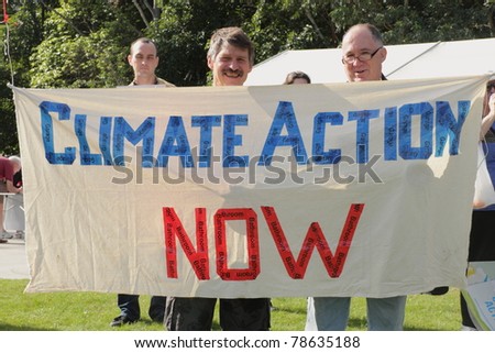 BRISBANE, AUSTRALIA - JUNE 6 : Men with climate action now sign at say Yes to carbon tax World Environment Day protest 6, 2011 in Brisbane, Australia
