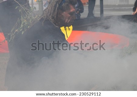 BRISBANE, AUSTRALIA - NOVEMBER 14: Unidentified activist conducting fire cleansing in Musgrave Park during g20 aboriginal deaths in custody protest on November 14, 2014 in Brisbane, Australia