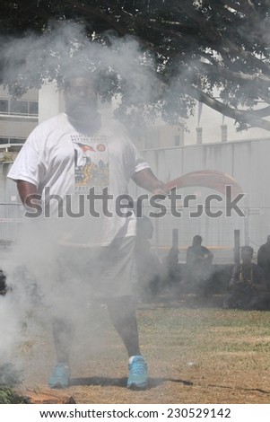 BRISBANE, AUSTRALIA - NOVEMBER 14: Unidentified activist speaking in front cleansing fire during g20 aboriginal deaths in custody protest on November 14, 2014 in Brisbane, Australia