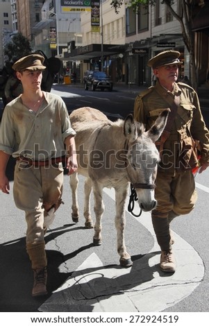 BRISBANE, AUSTRALIA - APRIL 25 : Simpson and his donkey  reenactors march along the route during Anzac day centenary commemorations April 25, 2015 in Brisbane, Australia