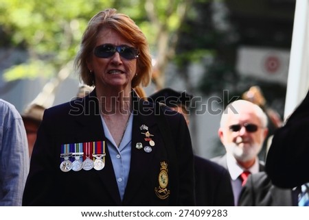 BRISBANE, AUSTRALIA - APRIL 25 : Female veteran marching during Anzac day centenary commemorations April 25, 2015 in Brisbane, Australia