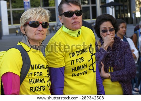 BRISBANE, AUSTRALIA - JUNE 20: Rally goers wearing Amnesty International supporter shirts at World Refugee Day Rally June 20, 2015 in Brisbane, Australia