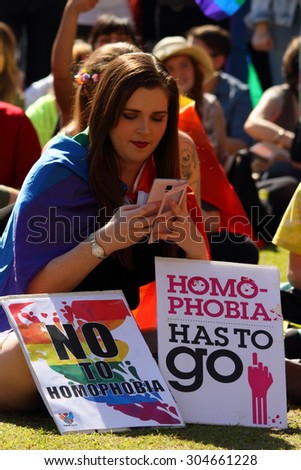 BRISBANE, AUSTRALIA - AUGUST 8 2015: Unidentified rally goer with anti homophobia sign at Marriage Equality Rally August 8, 2015 in Brisbane, Australia
