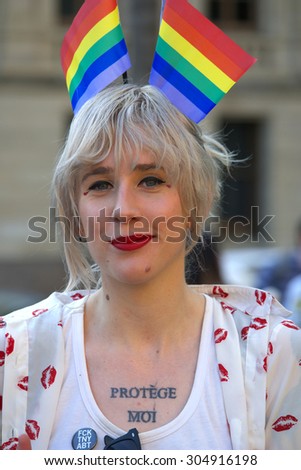 BRISBANE, AUSTRALIA - AUGUST 8 2015: Unidentified rally goer adorned with gay pride flags at Marriage Equality Rally August 8, 2015 in Brisbane, Australia