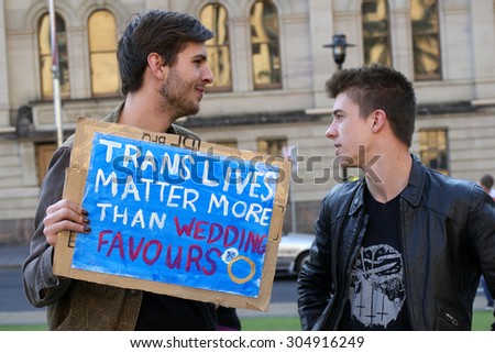 BRISBANE, AUSTRALIA - AUGUST 8 2015:Unidentified rally goers with trans sign at Marriage Equality Rally August 8, 2015 in Brisbane, Australia