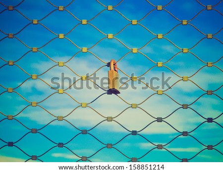 Padlock on a metal grid net fence vintage look