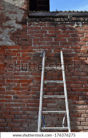 Ladder on an old red brick wall