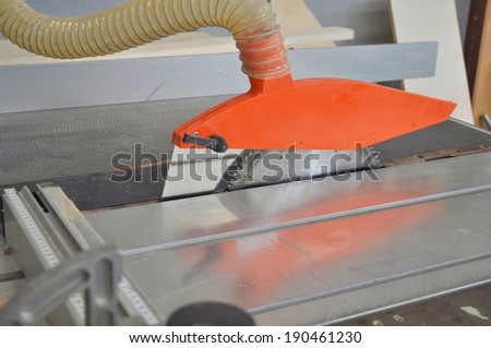 A table saw sawbench tool circular saw blade mounted on an arbor driven by an electric motor