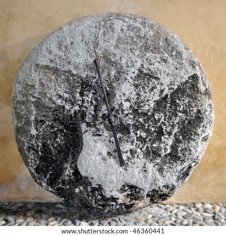 A mill stone used in wind and water mills for grinding wheat and grains