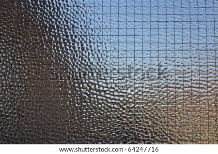 Decorated glass pane useful as a background