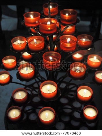 Lit votive prayer wax candles for church or home use