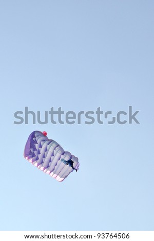 A parachute over a blue sky background