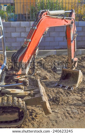 Excavator mechanical shovel digger digging a hole in the ground