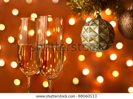 Two glasses of wine with a Christmas decor in the background.  focus on near glass.