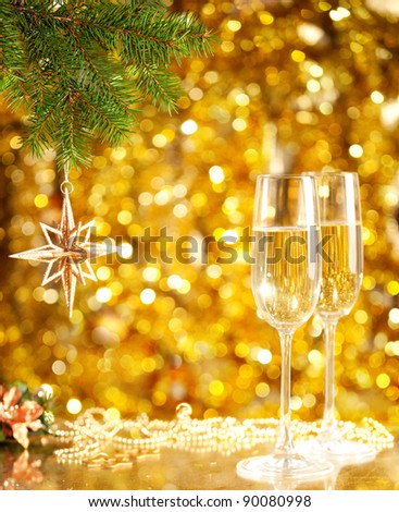 Two glasses of wine with a Christmas decor in the background. very shallow depth of field, focus on near glass.