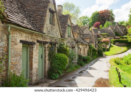 Old street with traditional cottages in  beautiful spring day , Bibury, England, UK.