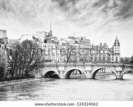 Pont Neuf in central Paris, France.  The Pont Neuf  is the oldest standing bridge across the river Seine in Paris.  Black and white.  Noise added