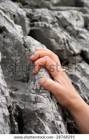 Closeup of a female Caucasian hand climbing up on a mountain