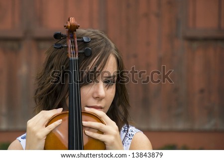 The violin player is waiting for the rest of the musicians to show up.