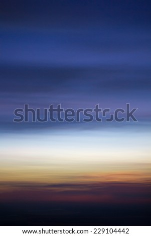 Abstract motion blur of sunset. Using motion blur from camera to blur photo to look like abstract background.