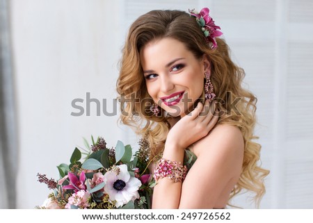 Glamour portrait of beautiful woman model with red lips and long blond hair and Stylish Designer Wedding Flowers