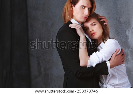 Sexy passion couple, beautiful young man and woman closeup, studio shot over black. Beauty and Fashion.