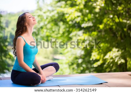 Woman on a yoga mat to relax outdoor.