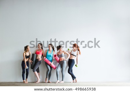 Smiling women in fitness studio. Fitness, sport, training and lifestyle concept.