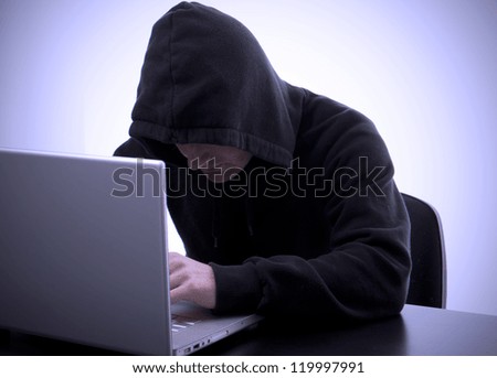 hacker writing on a laptop and data safety