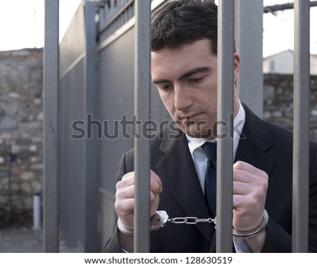 corrupted manager going in jail with handcuffs