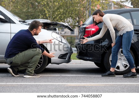 People arguing after a car crash and trying to find friendly agreement