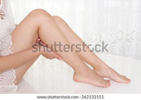 A woman takes care of her legs