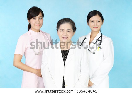 Smiling medical stuff and an old lady