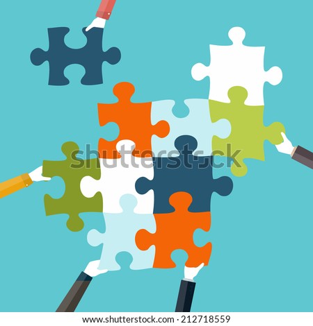 Concept of teamwork and integration with businessman holding colorful puzzle