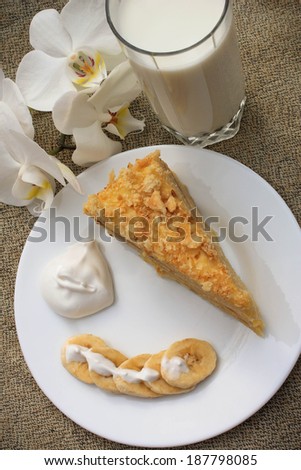 Breakfast with milk, cake, banana and cream