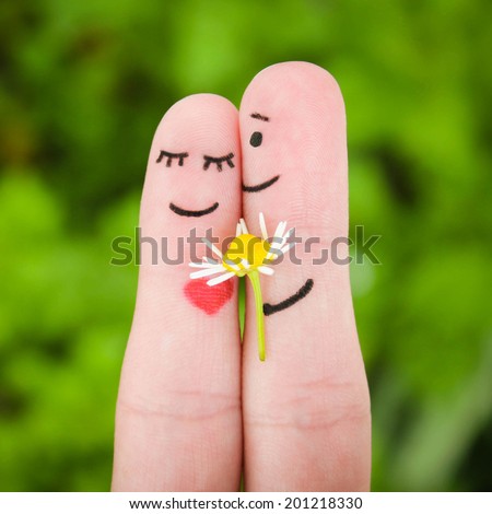 Happy couple Man is giving flowers to a woman Happy couple Man is giving flowers to a woman