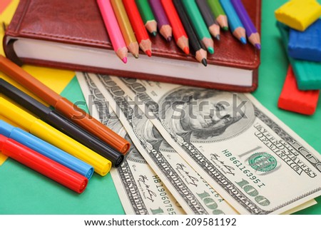 Pens, colored pencils, plasticine, book, hundred dollar bills