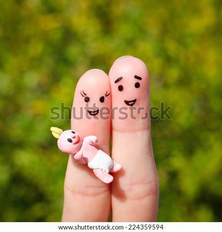 Finger art of a Happy couple. Happy family holding a small child