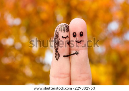 Finger art of a Happy couple. Girl kisses boy on the cheek.