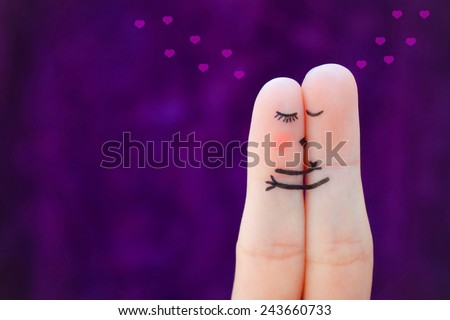 Finger art of a Happy couple. Couple kissing and hugging on the background of hearts