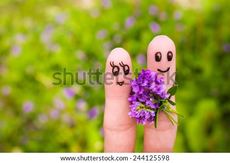 Finger art of a Happy couple.  Man is giving flowers to a woman.