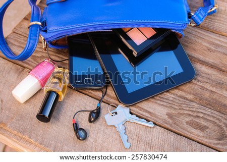 Blue women's purse. Things from open lady handbag.