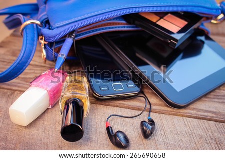 Blue women\'s purse. Things from open lady handbag.