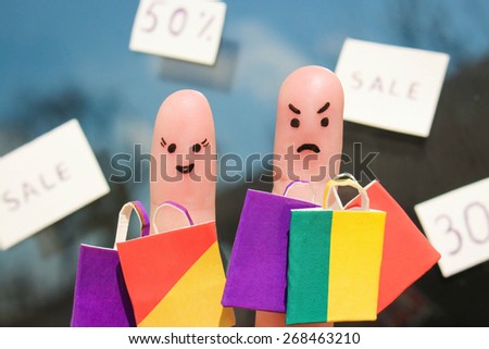 Finger art of a couple with shopping bags. Man is unhappy because he was tired of shopping.