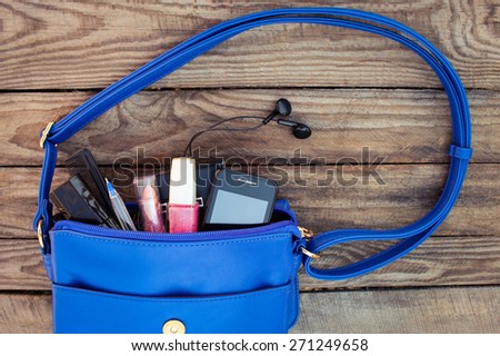 Blue women\'s purse. Things from open lady handbag